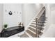 Cozy entryway with storage bench, coat hooks, and stairs with dark iron spindles at 5328 Brookgrove Dr, Sarasota, FL 34238