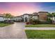 Luxury home showing landscaping and a paver driveway as well as a grass lawn at 5328 Brookgrove Dr, Sarasota, FL 34238