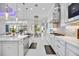 A bright modern kitchen featuring an island, stainless appliances, and view to outdoor living through a nearby dining area at 5328 Brookgrove Dr, Sarasota, FL 34238