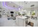 Modern kitchen view of a large island, stainless steel appliances, and an open floor plan with view of a backyard pool at 5328 Brookgrove Dr, Sarasota, FL 34238
