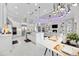 Open-concept design with modern white kitchen featuring an island, stainless steel appliances, and view into the adjacent living room at 5328 Brookgrove Dr, Sarasota, FL 34238
