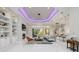 Spacious living room with white tile flooring, fireplace, and an open layout connecting to the kitchen at 5328 Brookgrove Dr, Sarasota, FL 34238