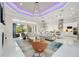 Open-concept living room with tile flooring, modern lighting, and a seamless flow to the outdoor patio at 5328 Brookgrove Dr, Sarasota, FL 34238