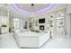 Bright living room featuring white tile floors, fireplace, and custom built-ins with decorative lighting at 5328 Brookgrove Dr, Sarasota, FL 34238