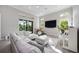 Bright living room with hardwood floors, sectional sofa, high ceilings, large windows, piano, and drum set at 5328 Brookgrove Dr, Sarasota, FL 34238