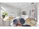Bright living room with hardwood floors, piano, high ceilings, large windows, and a drum set at 5328 Brookgrove Dr, Sarasota, FL 34238