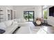 Bright living room with hardwood floors, sectional sofa, high ceilings, pool views, and a drum set at 5328 Brookgrove Dr, Sarasota, FL 34238