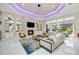 Elegant living room featuring tile flooring, built-in shelving, and a cozy fireplace, and ample natural light at 5328 Brookgrove Dr, Sarasota, FL 34238