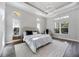 Bright main bedroom featuring a modern chandelier, stylish furnishings, and natural light from multiple windows at 5328 Brookgrove Dr, Sarasota, FL 34238