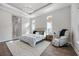 Bright main bedroom with a modern lighting fixture, stylish furnishings, and an area to relax in at 5328 Brookgrove Dr, Sarasota, FL 34238