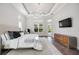 Beautiful main bedroom with a large window, TV, and a comfortable area for relaxing and enjoying the view at 5328 Brookgrove Dr, Sarasota, FL 34238