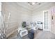 Home office featuring a modern glass desk, ample natural light from a large arched window, and crown molding at 5328 Brookgrove Dr, Sarasota, FL 34238