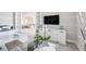 Home office featuring a modern glass desk, ample natural light from a large arched window, and crown molding at 5328 Brookgrove Dr, Sarasota, FL 34238