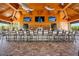Inviting outdoor bar with wooden accents, multiple TVs, ample seating, and a relaxed atmosphere at 5328 Brookgrove Dr, Sarasota, FL 34238