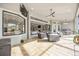 Spacious outdoor living area with tile flooring, comfortable seating, and views of the interior at 5328 Brookgrove Dr, Sarasota, FL 34238