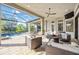 Relaxing outdoor living space with comfortable seating and views of the pool and lush landscaping at 5328 Brookgrove Dr, Sarasota, FL 34238