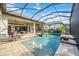 Backyard pool with screened-in lanai, with water fountains and spillover spa tub at 5328 Brookgrove Dr, Sarasota, FL 34238