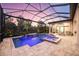 Screened-in pool area with a beautiful pool, a waterfall, a spa, fountains, tile flooring, and lounge chairs for relaxation at 5328 Brookgrove Dr, Sarasota, FL 34238