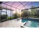 Beautiful backyard pool with a screened-in lanai, lush landscaping, and relaxing spa at 5328 Brookgrove Dr, Sarasota, FL 34238