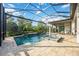 Screened in swimming pool, attached spa, and waterfall features surrounded by lush landscaping at 5328 Brookgrove Dr, Sarasota, FL 34238