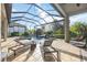 Outdoor living space with pool, spa, waterfall, and covered patio lounge area, perfect for relaxing at 5328 Brookgrove Dr, Sarasota, FL 34238