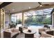 Relaxing outdoor seating area on the lanai with an outdoor kitchen and pool view at 5328 Brookgrove Dr, Sarasota, FL 34238