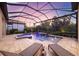 Screened-in pool area with a beautiful pool, a waterfall, a spa, fountains, tile flooring, and lounge chairs for relaxation at 5328 Brookgrove Dr, Sarasota, FL 34238