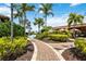 Scenic walkway surrounded by lush landscaping, leading to the pool and outdoor bar, creating a serene environment at 5328 Brookgrove Dr, Sarasota, FL 34238