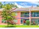 Condo with a screened balcony overlooking a lush green backyard at 5500 Longwood Run Blvd # 203, Sarasota, FL 34243