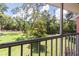 Serene view from the screened-in patio overlooking the lush green backyard at 5500 Longwood Run Blvd # 203, Sarasota, FL 34243
