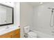 Bathroom featuring tub with tile surround and shower head, toilet, and sink at 5500 Longwood Run Blvd # 203, Sarasota, FL 34243