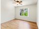 A bedroom with hardwood flooring and a window, and a ceiling fan at 5500 Longwood Run Blvd # 203, Sarasota, FL 34243