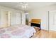 This bedroom includes an ensuite bathroom, wood flooring, and a ceiling fan at 5500 Longwood Run Blvd # 203, Sarasota, FL 34243