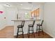 Cozy kitchen featuring a breakfast bar with seating and clean white walls at 5500 Longwood Run Blvd # 203, Sarasota, FL 34243
