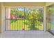 Screened patio with an outdoor view of mature trees and green space at 5500 Longwood Run Blvd # 203, Sarasota, FL 34243