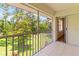 Screened patio with an outdoor view of mature trees and green space at 5500 Longwood Run Blvd # 203, Sarasota, FL 34243