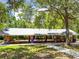 Large picnic shelter for community gatherings and outdoor dining, surrounded by lush greenery at 5500 Longwood Run Blvd # 203, Sarasota, FL 34243