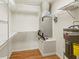 Utility room featuring open shelving, water heater, and HVAC unit at 5500 Longwood Run Blvd # 203, Sarasota, FL 34243