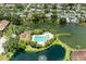 Stunning aerial view of the community pool surrounded by lush greenery and tranquil ponds at 5728 Ashton Lake Dr # 12, Sarasota, FL 34231