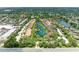 Scenic aerial view of residential community with lake, fountains, mature trees, and well-maintained landscaping at 5728 Ashton Lake Dr # 12, Sarasota, FL 34231