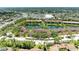 Aerial view of a residential community with multiple buildings surrounding a picturesque lake at 5728 Ashton Lake Dr # 12, Sarasota, FL 34231