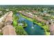 Aerial view showcasing serene lakefront community with lush greenery, a swimming pool, and fountains at 5728 Ashton Lake Dr # 12, Sarasota, FL 34231