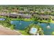 Overhead view of residential community on lake with a pool, lush tropical landscaping, and fountains at 5728 Ashton Lake Dr # 12, Sarasota, FL 34231
