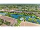 Aerial view of waterfront community featuring a pool area, lush greenery, and fountains at 5728 Ashton Lake Dr # 12, Sarasota, FL 34231