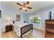 Cozy bedroom features a decorative ceiling fan and light-filled window at 5728 Ashton Lake Dr # 12, Sarasota, FL 34231