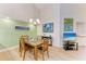 Dining room with a modern chandelier, stylish artwork, and light-colored flooring at 5728 Ashton Lake Dr # 12, Sarasota, FL 34231