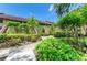 Exterior walkway landscaped with trees, plants and stairs leading to units at 5728 Ashton Lake Dr # 12, Sarasota, FL 34231