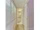 Hallway view leading to a bathroom with a convenient closet for storage at 5728 Ashton Lake Dr # 12, Sarasota, FL 34231