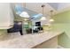 Bright kitchen with white cabinets, stainless steel appliances, and breakfast bar at 5728 Ashton Lake Dr # 12, Sarasota, FL 34231