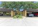 Covered parking area with designated parking spots and verdant landscaping at 5728 Ashton Lake Dr # 12, Sarasota, FL 34231